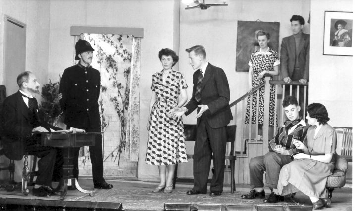 Walpole Wyndrum, Sergeant Gannett, Chickie Buff, Hugo Bonsor, (Stairs:) Oeone, Osbert Bassinton-Bassington, (Sitting:) Geoffrey, Hermia Wyndrum