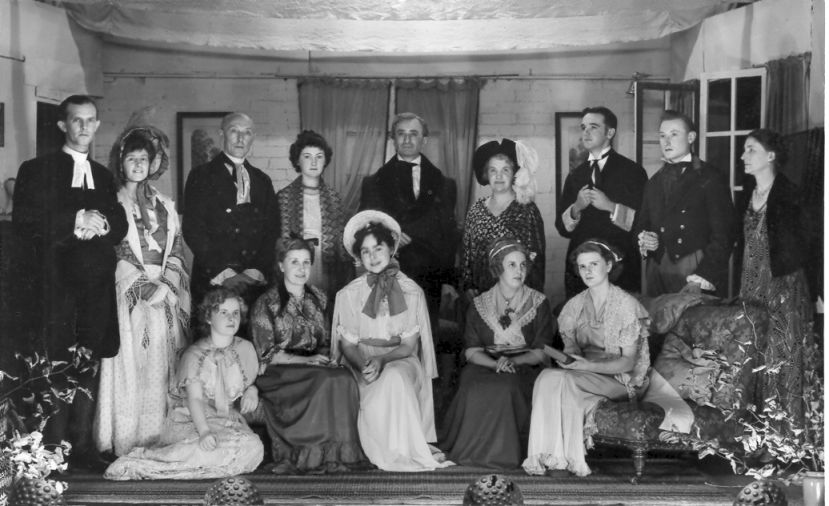 (Back row:) William Collins, Charlotte Lucas, Mr Bennett, Elizabeth Bennet, Fitzwilliam Darcy, Caroline Bingley & Lady Catherine de Burgh, Manservant, Charlie Bingley, Producer (Miss L Angell) (Sitting:) Kitty Bennett, Mrs Bennett, Lydia Bennett, Jane Bennett, Mary Bennett
